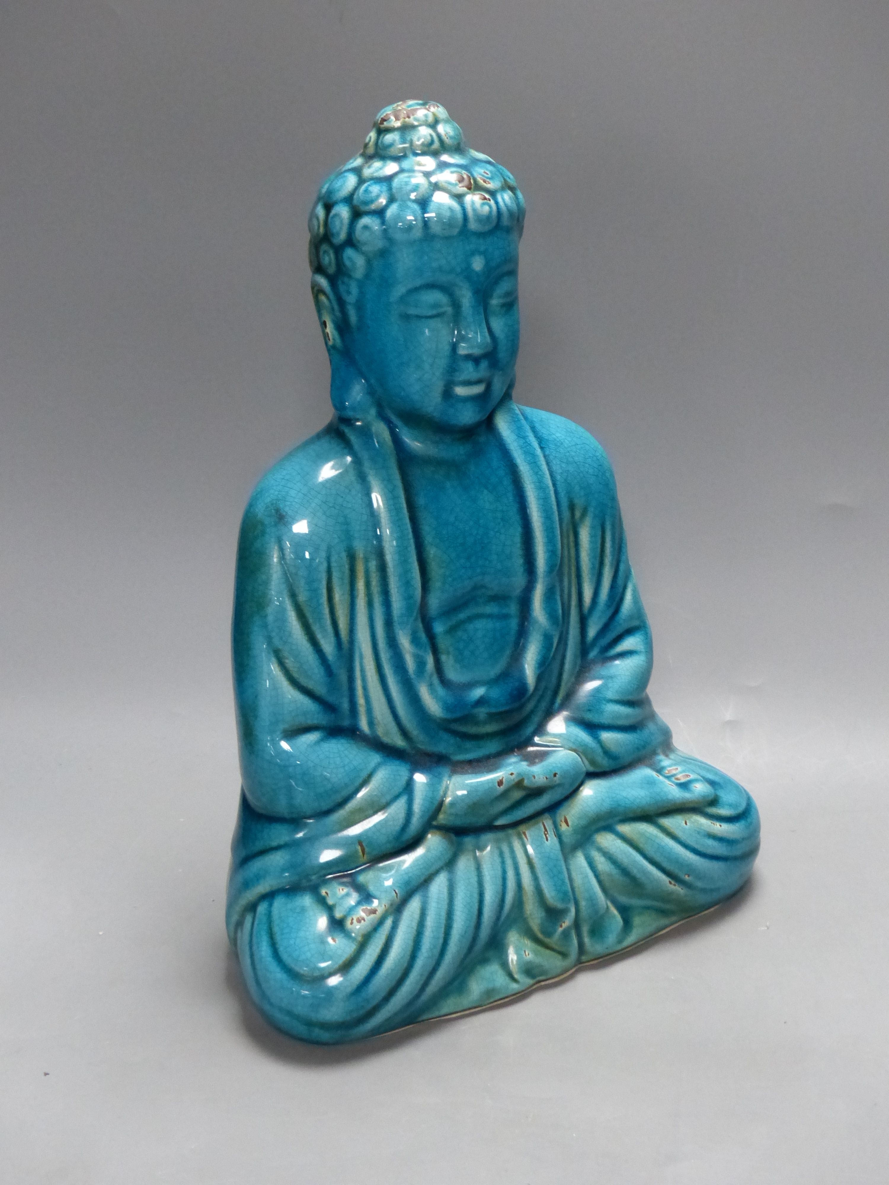 A Chinese ceramic buddha, height 40cm, a blue and white dish, and two leather wall hangings, Qing period or later